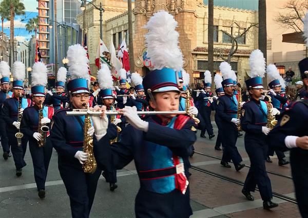 Close up of high school marching band members performing on wind instruments Close up of high school marching band members performing on wind instruments